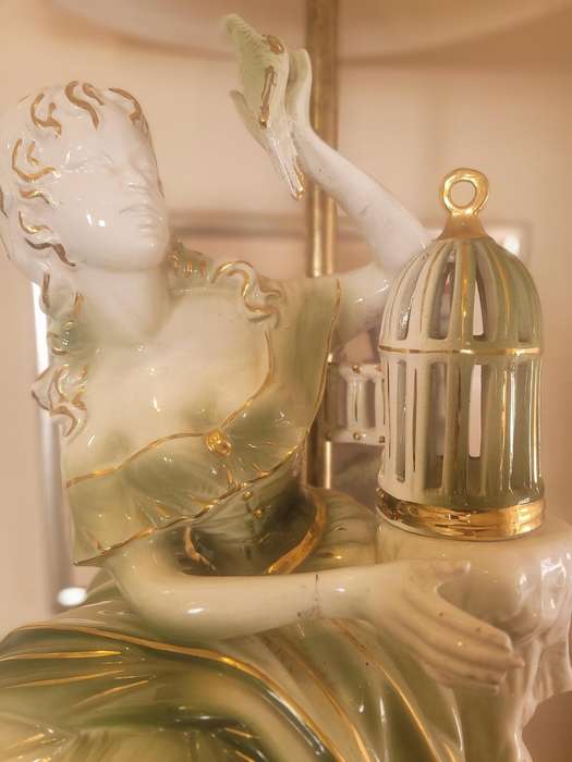 GILDED LADY WITH A BIRD FROM A CAGE, CERAMIC-FITTED TO BE A LAMP-FIGURINE 55CM HIGH