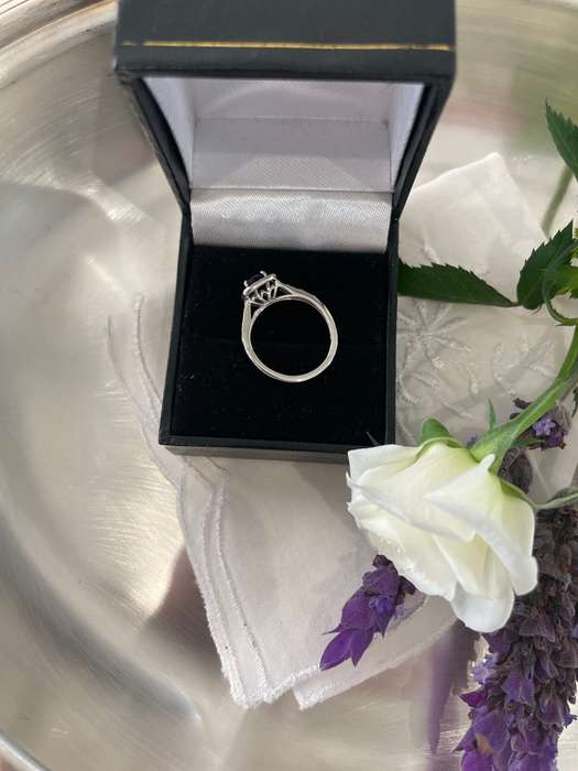 Sterling silver 925 ring featuring a blue gemstone, set in a 925 silver band with cubic zirconia's.