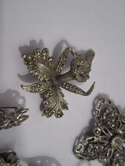 3 x Brooches and 1 pair clip on earrings