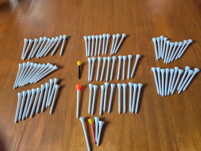 84 wooden golf tees. Look unused.