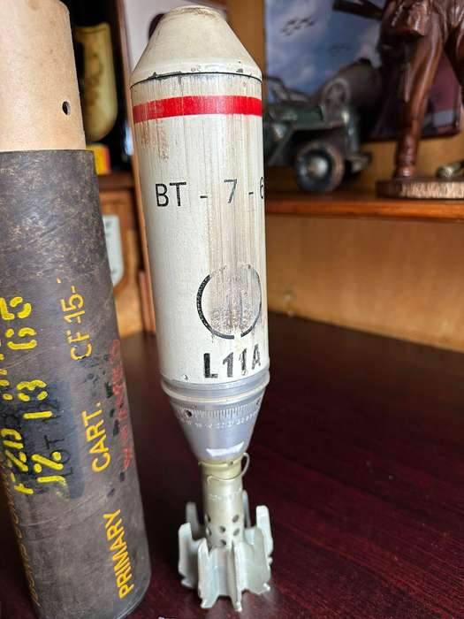 60 MM illuminating bomb type 62 in complete condition ,with range table and holder. Inert