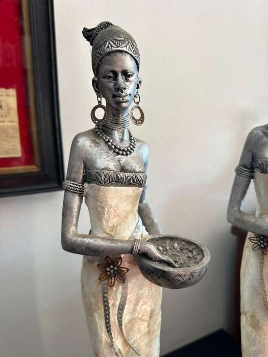 Three decorative composite moulded figurines,decorated with applied mother of pearl. Height of talle
