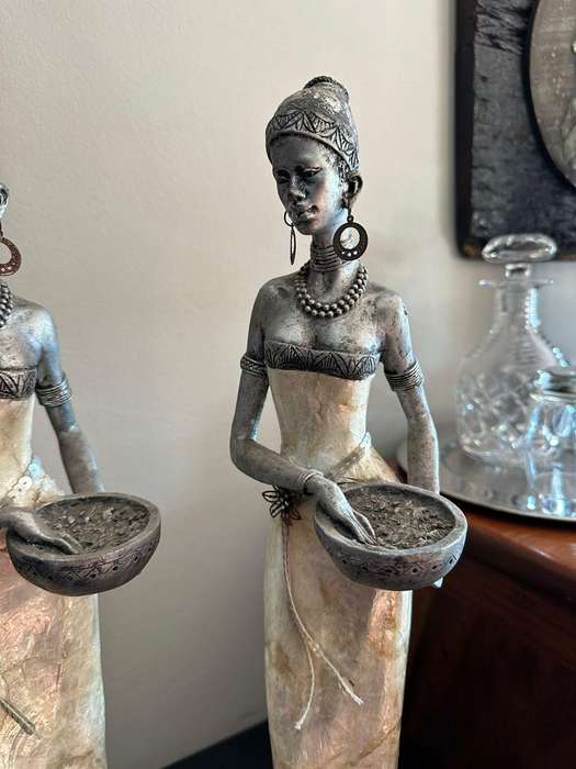 Three decorative composite moulded figurines,decorated with applied mother of pearl. Height of talle