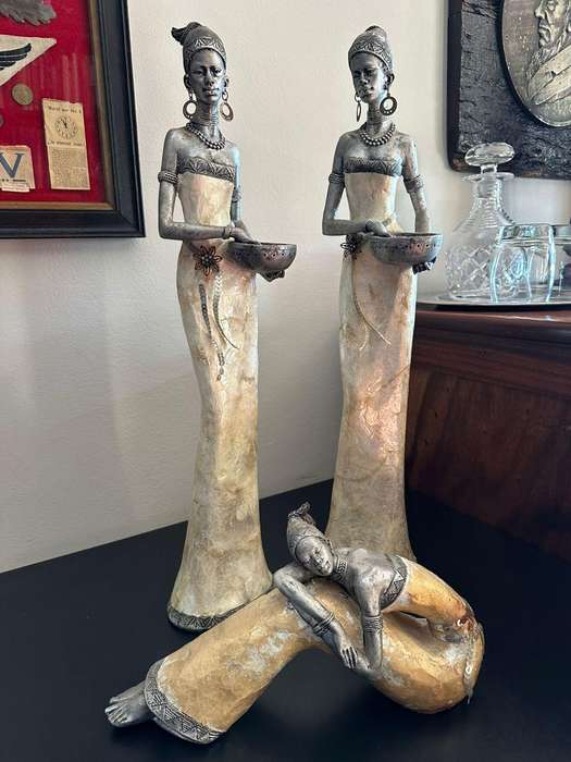 Three decorative composite moulded figurines,decorated with applied mother of pearl. Height of talle