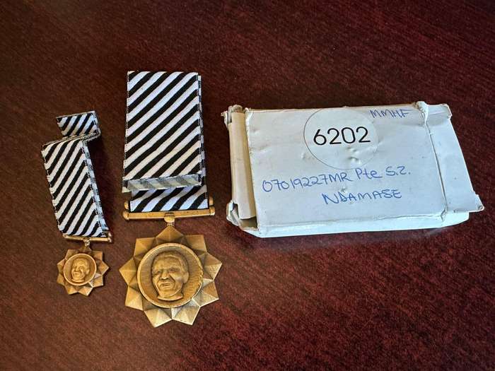 Bronze Mandela medals. Full size and miniature. The full size is numbered, comes with original issue