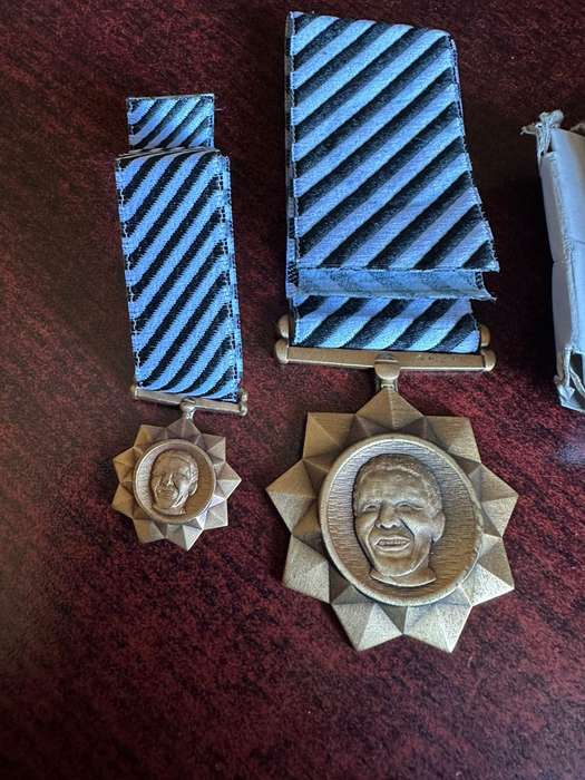 Bronze Mandela medals. Full size and miniature. The full size is numbered, comes with original issue