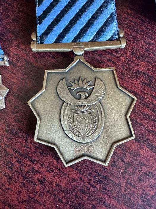 Bronze Mandela medals. Full size and miniature. The full size is numbered, comes with original issue