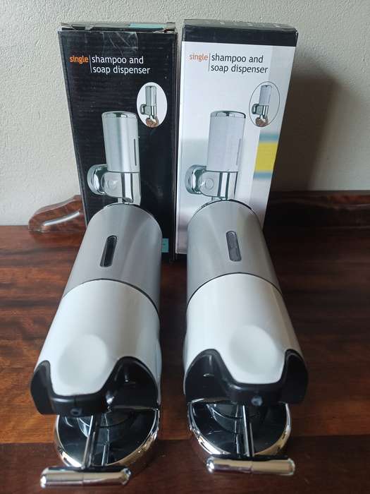 Two shampoo and soap dispensers in boxes, never been used