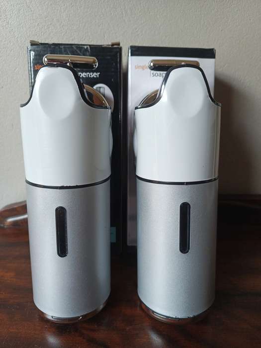 Two shampoo and soap dispensers in boxes, never been used