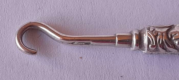 Edwardian All Solid Silver Miniature Glove Hook Pendant. Adie & Lovekin, Birmingham.