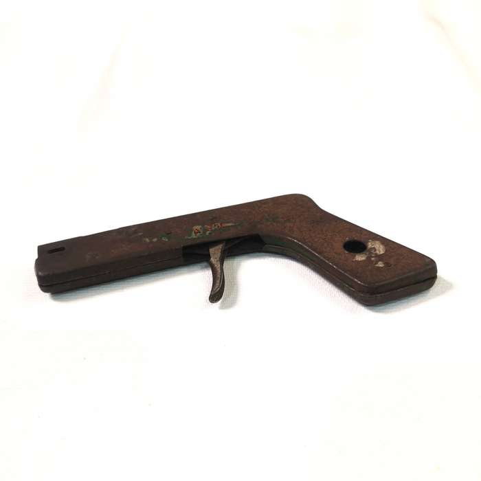 A nice old vintage flint lighter for gas stoves in the shape of a pistol with trigger action