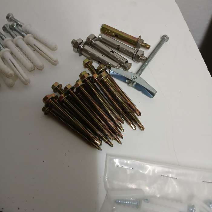 assortment of fasteners, primarily screws and nails
