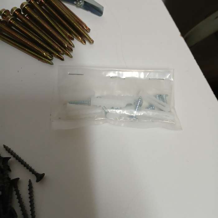 assortment of fasteners, primarily screws and nails