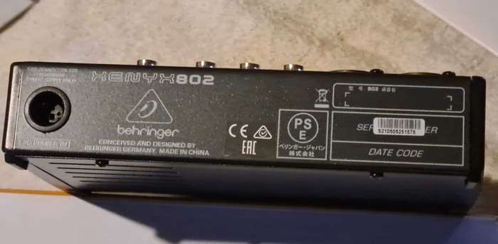 Behringer Xenyx 802 audio mixer. It's a compact, 8-input mixer.