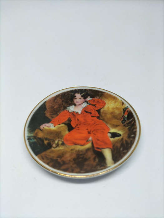 Decorative miniature ceramic plate featuring "The Red Boy"