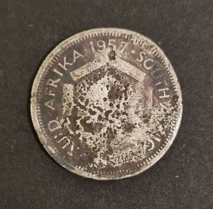 1957 South African 6 pence - extremely damaged