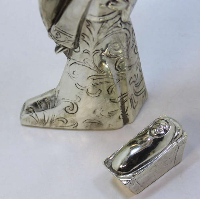 Figurine Of The Angel Gabriel Looking Over Baby Jesus In The Manger
