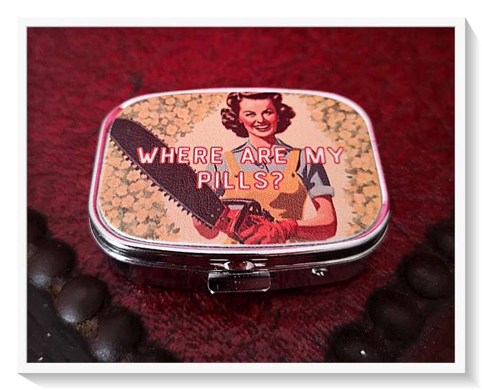 A Quirky Vintage Style Pill Box with a Chainsaw Wielding Lady on the Cover