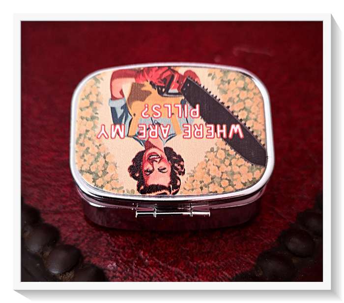 A Quirky Vintage Style Pill Box with a Chainsaw Wielding Lady on the Cover