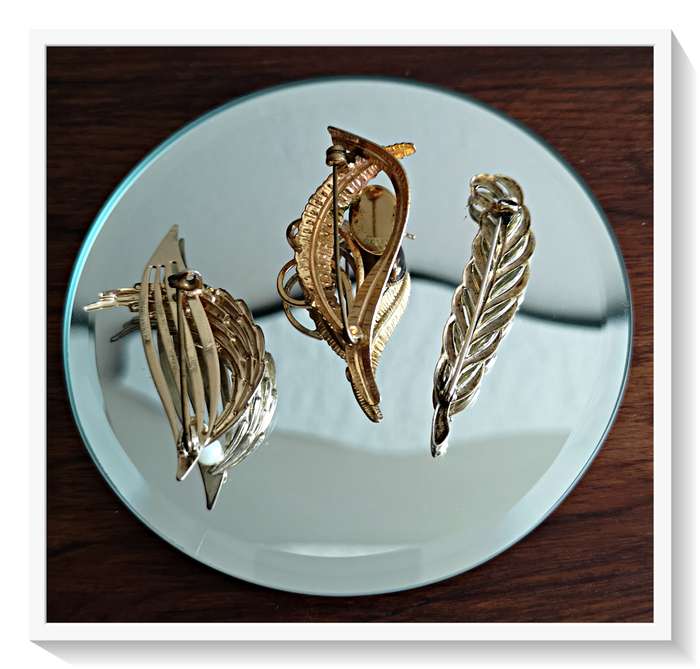 A Vintage Trio of Gold Plant Like Motif Brooches including an Oval Tigers Eye