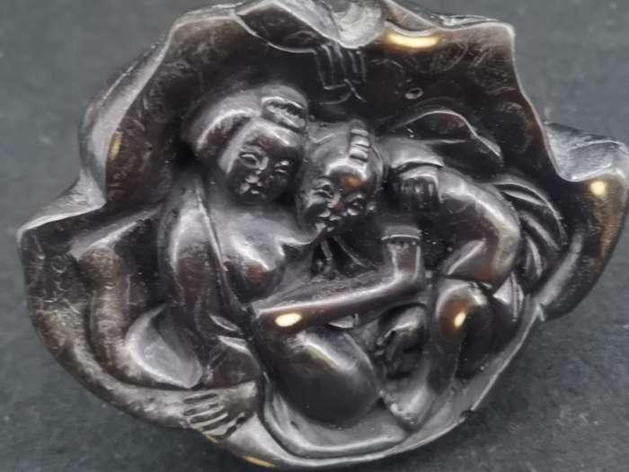 Buddha with Kama Sutra scene at the bottom