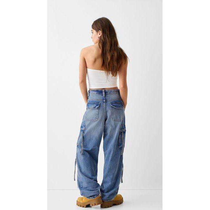 Denim baggy cargo jeans with straps.