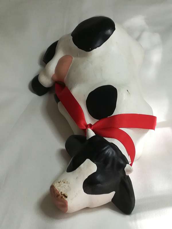 Black & White Ceramic Cow with Red Ribbon Around The Neck