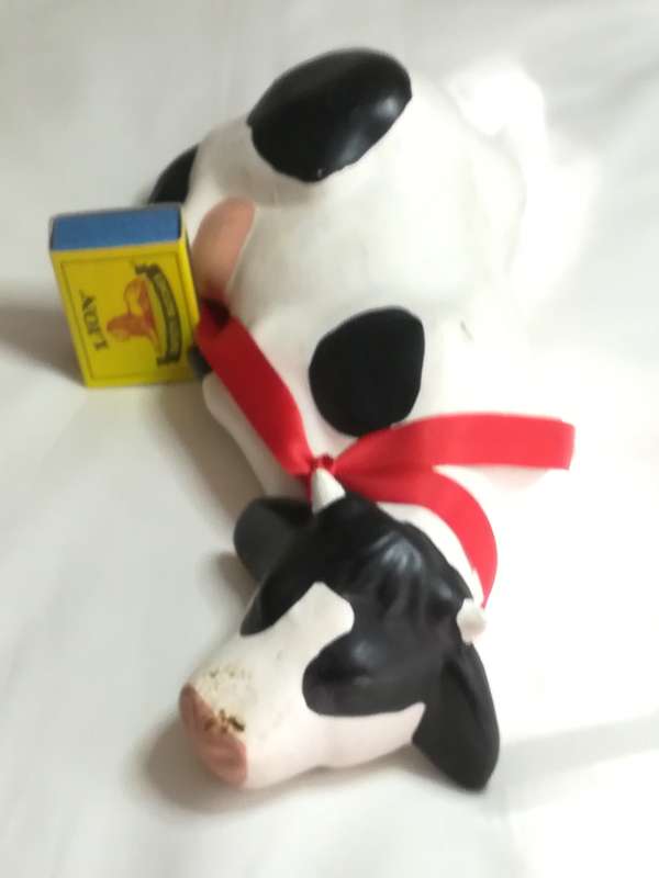 Black & White Ceramic Cow with Red Ribbon Around The Neck
