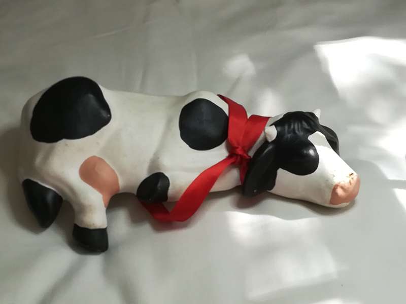 Black & White Ceramic Cow with Red Ribbon Around The Neck