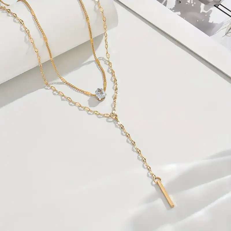 Multi Layered Gold Tone Necklace with White Gemstone