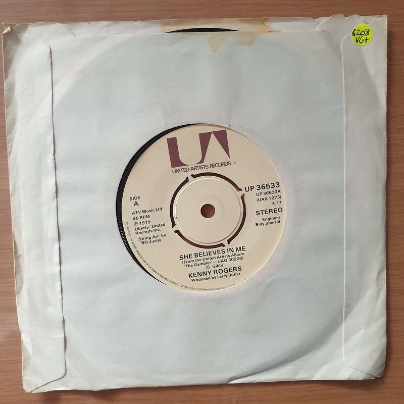 Kenny Rogers  She Believes In Me  - Vinyl 7" Record - Very-Good+ Quality (VG+) (verygoodplus7)