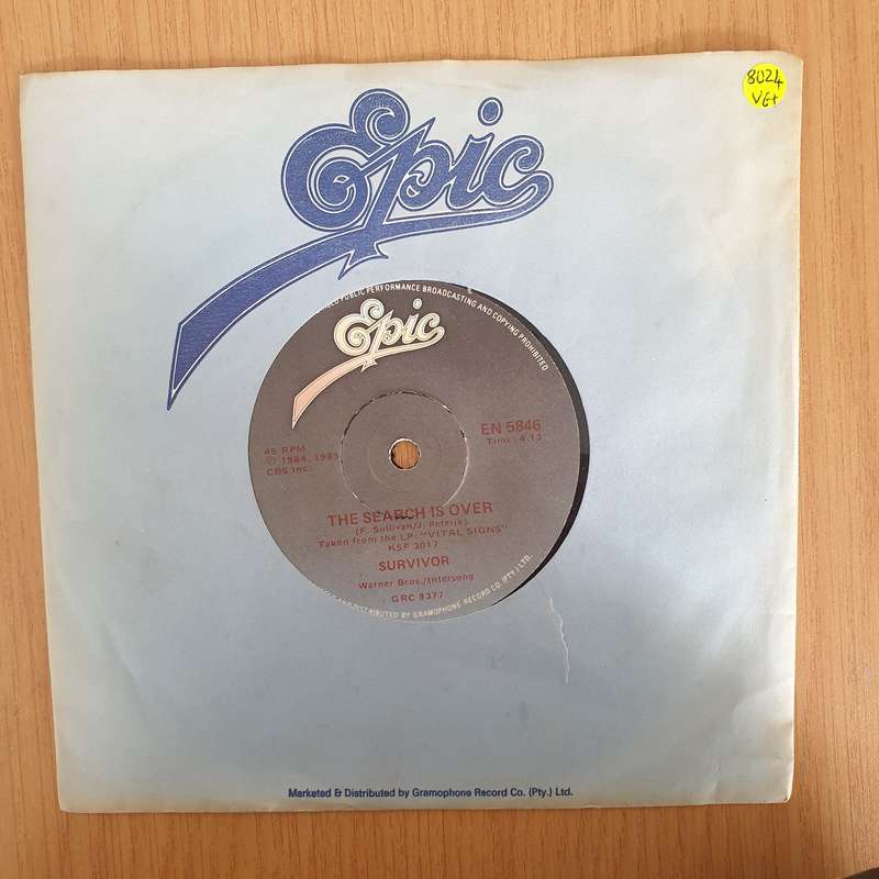 Survivor  The Search Is Over - 7" Vinyl Record  (VG+) (DLB)