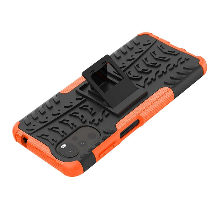 For Motorola Moto G22/E32 Tire Texture TPU + PC Phone Case with Holder(Orange)