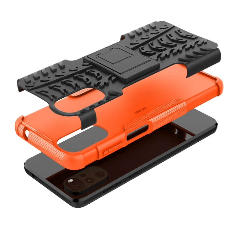 For Motorola Moto G22/E32 Tire Texture TPU + PC Phone Case with Holder(Orange)