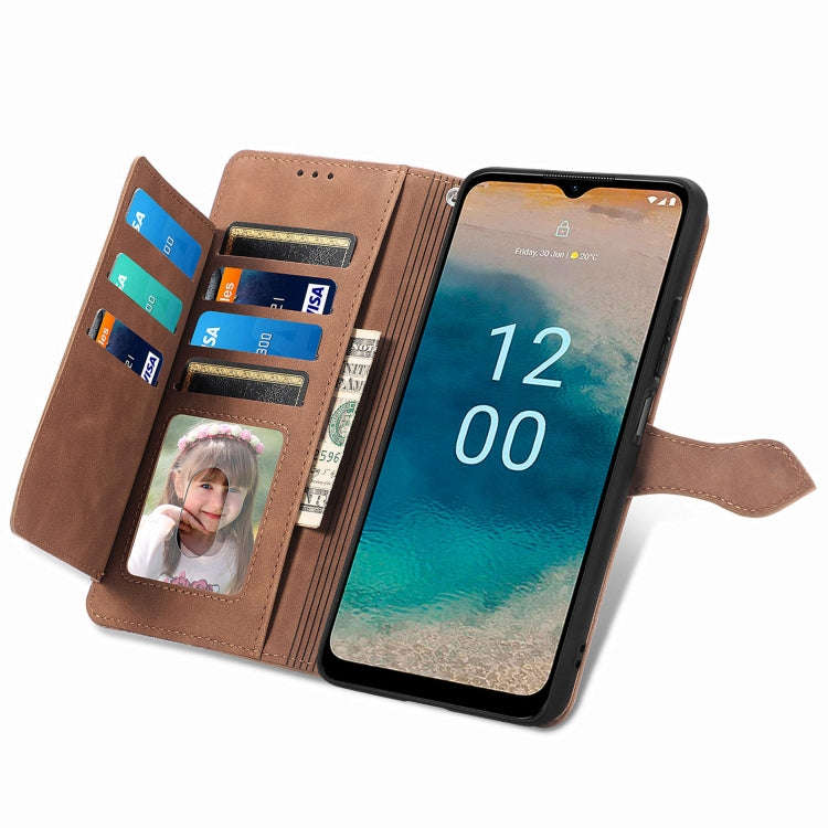 For Nokia G22 Embossed Flower Zipper Leather Phone Case(Brown)