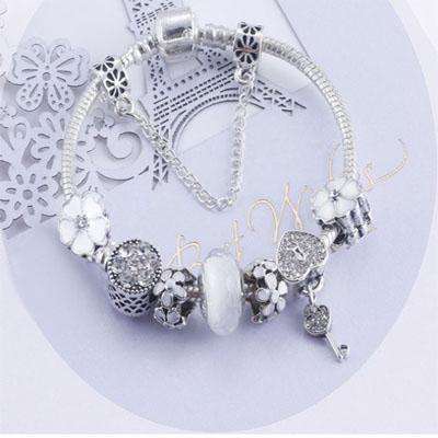 Charming White and Silver bracelet with Heart Locket and Flower themed charms