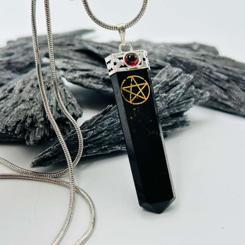 Black Tourmaline Pentacle Pendant Encased In White Metal With A Garnet Cabochon