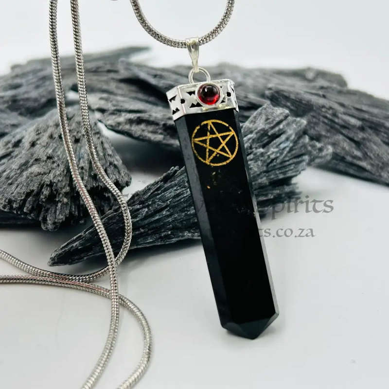 Black Tourmaline Pentacle Pendant Encased In White Metal With A Garnet Cabochon