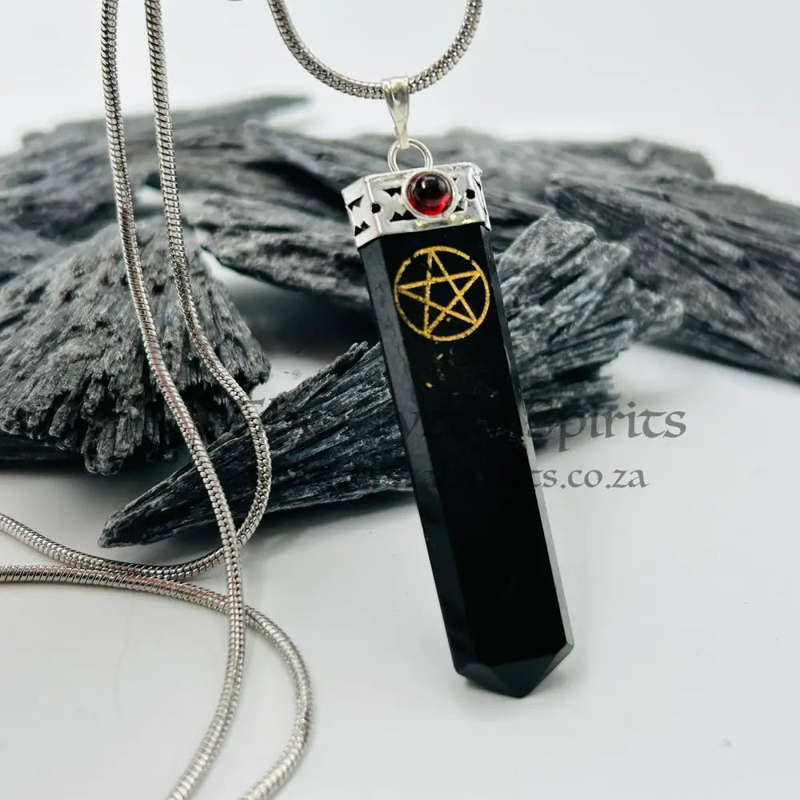 Black Tourmaline Pentacle Pendant Encased In White Metal With A Garnet Cabochon