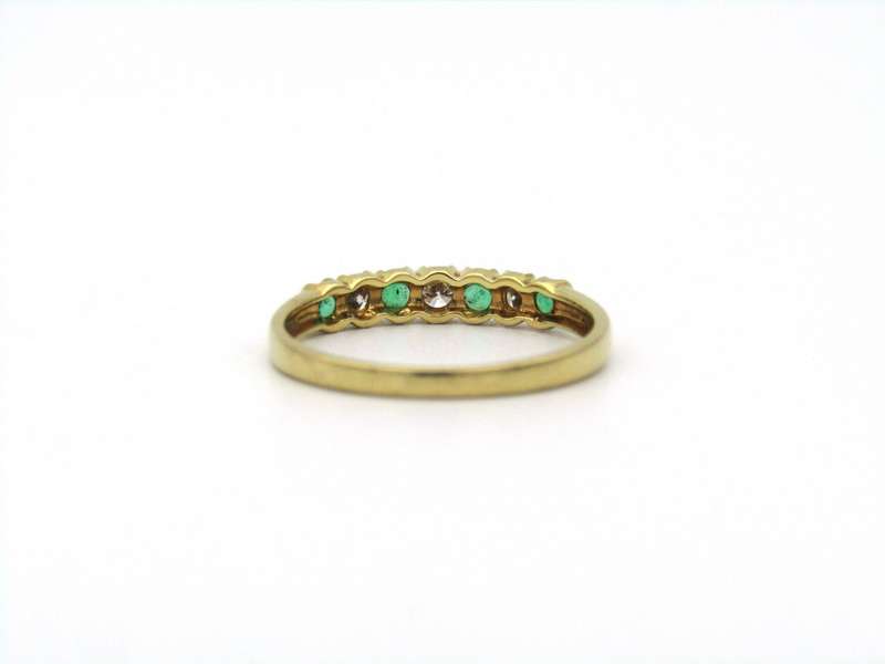 18K gold emerald and diamond ring.