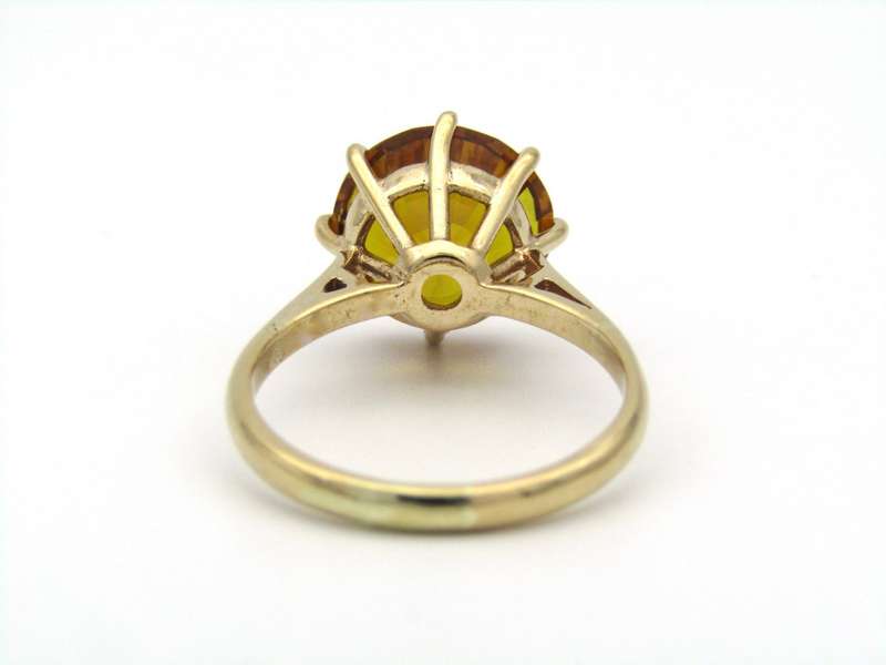9K gold synthetic yellow sapphire ring.