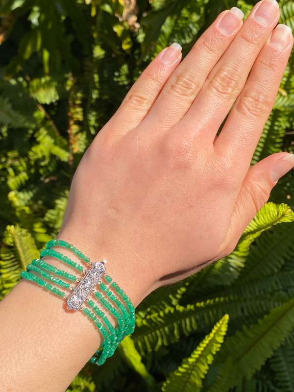 14K gold diamond and 5 strand emerald bracelet.