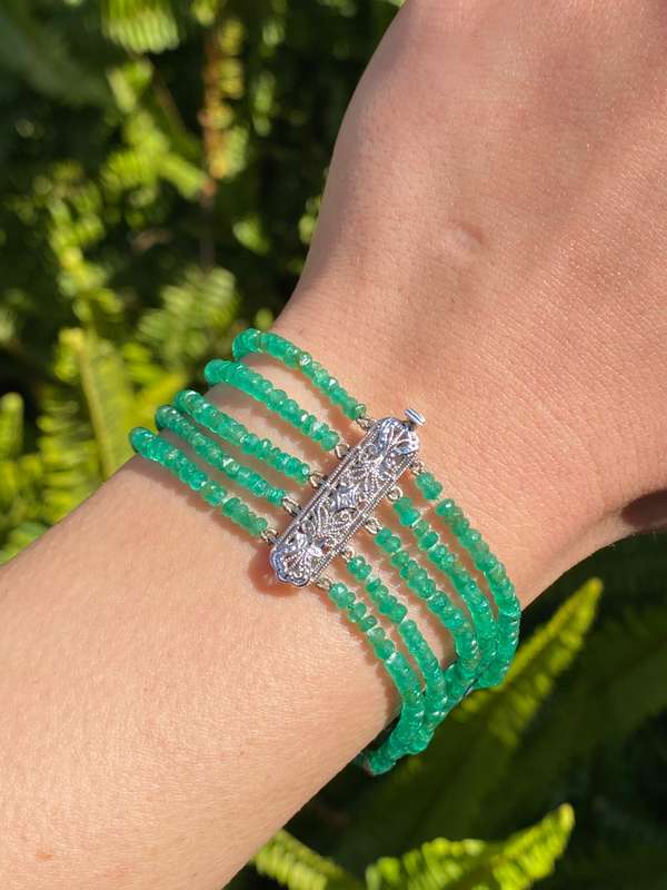 14K gold diamond and 5 strand emerald bracelet.