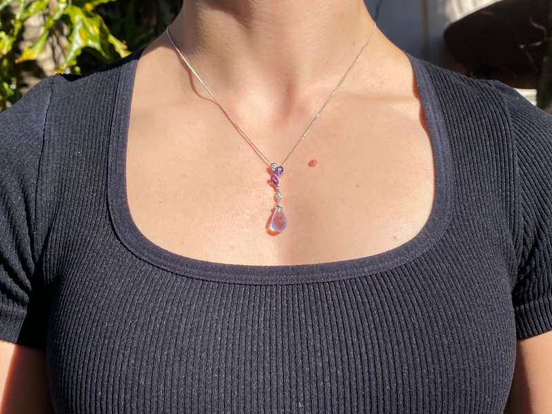 18K gold blue topaz, amethyst, and diamond pendant.