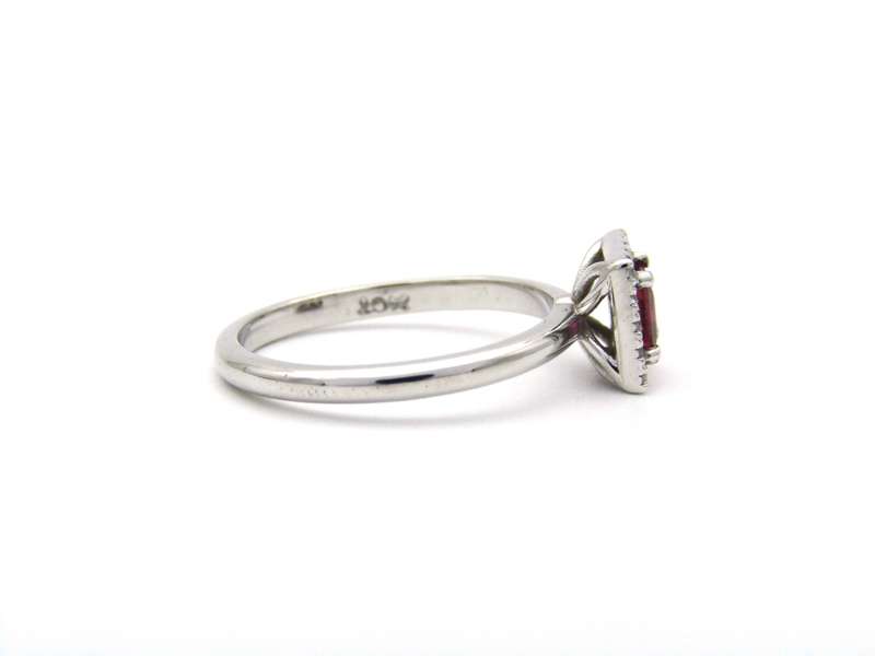 14K gold ruby and diamond halo ring.