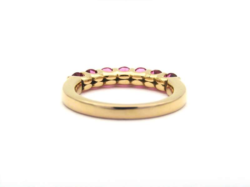 18K gold pink tourmaline half eternity ring by Jack Friedman.