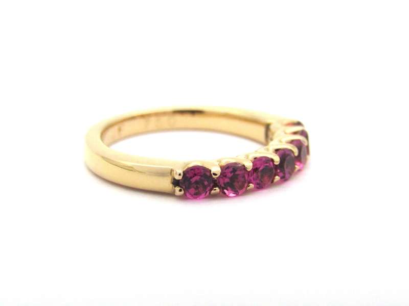 18K gold pink tourmaline half eternity ring by Jack Friedman.