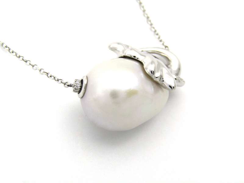 14K gold floating baroque pearl and diamond elephant necklace.