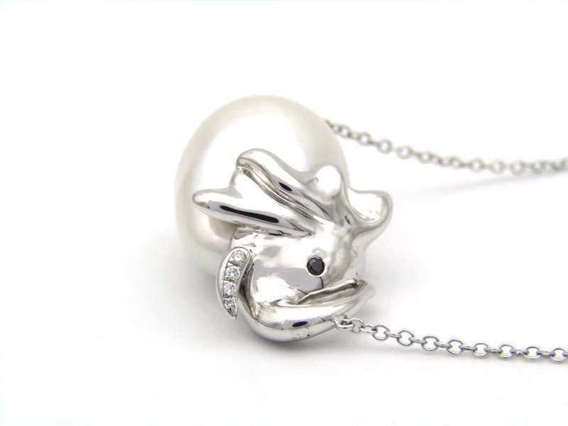 14K gold floating baroque pearl and diamond elephant necklace.