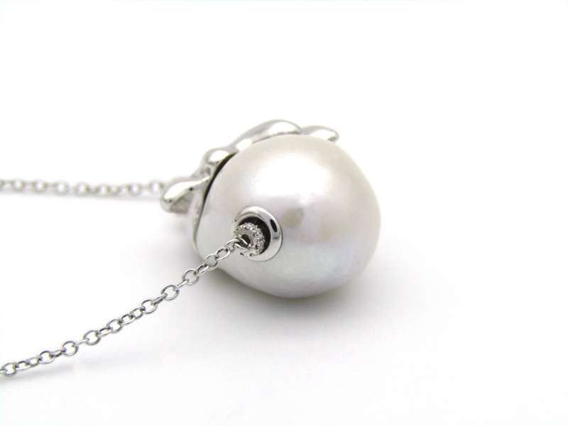 14K gold floating baroque pearl and diamond elephant necklace.